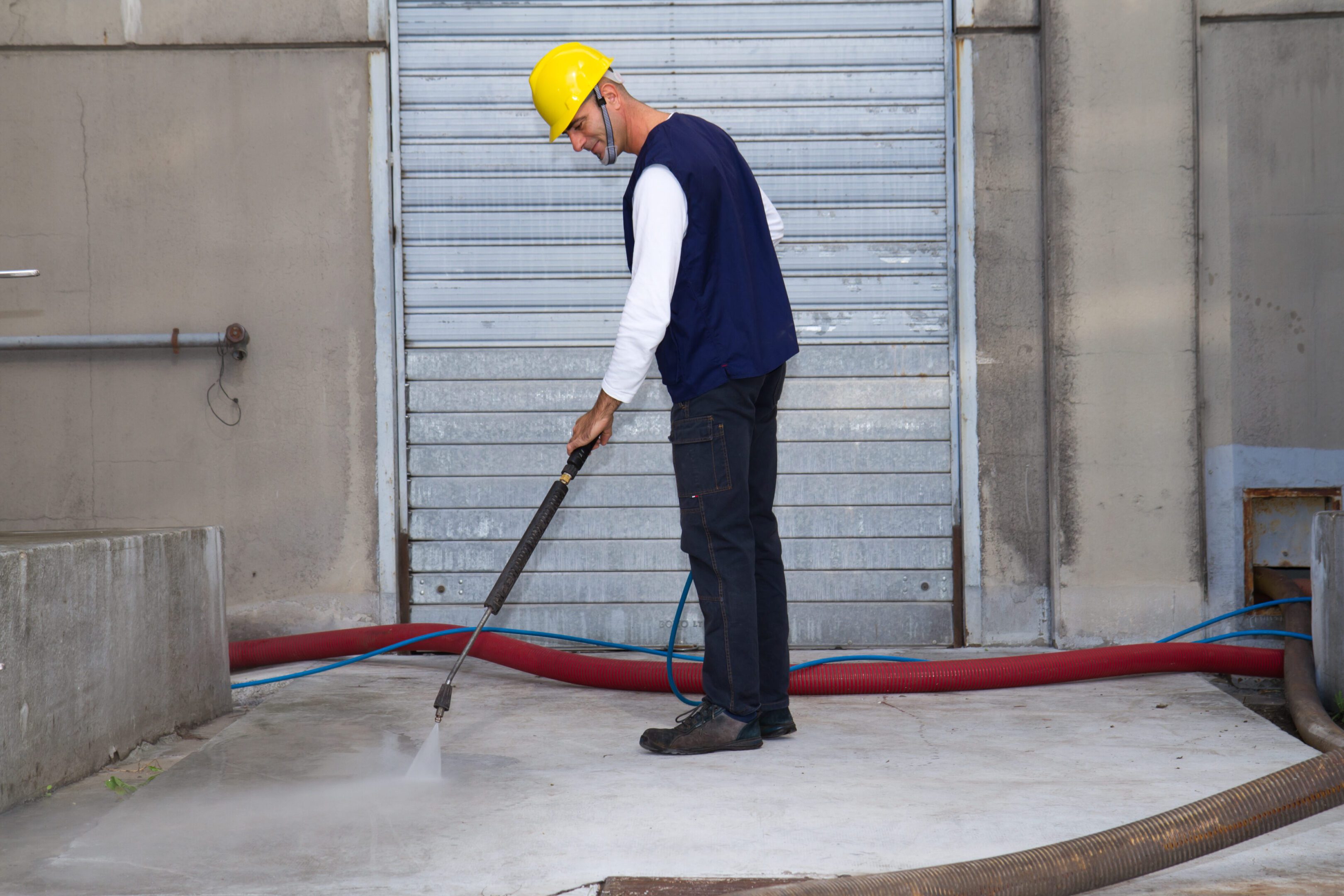 electrician and general worker washing the floor electrician and general worker washing the industrial site in a wine company