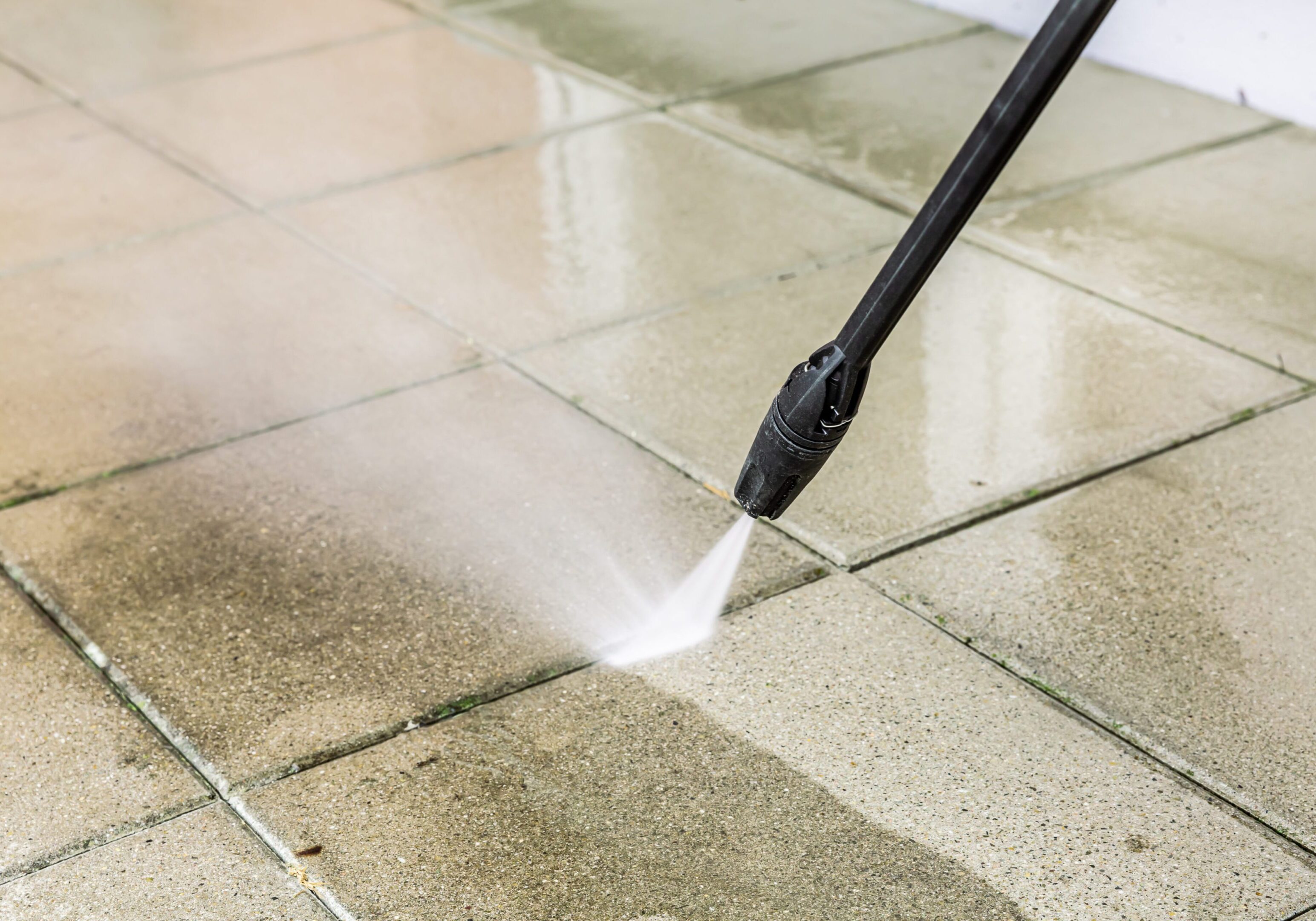 Detail of cleaning terrace with high-pressure water blaster, cleaning dirty paving stones Detail of cleaning terrace with high-pressure water blaster, cleaning dirty paving stones